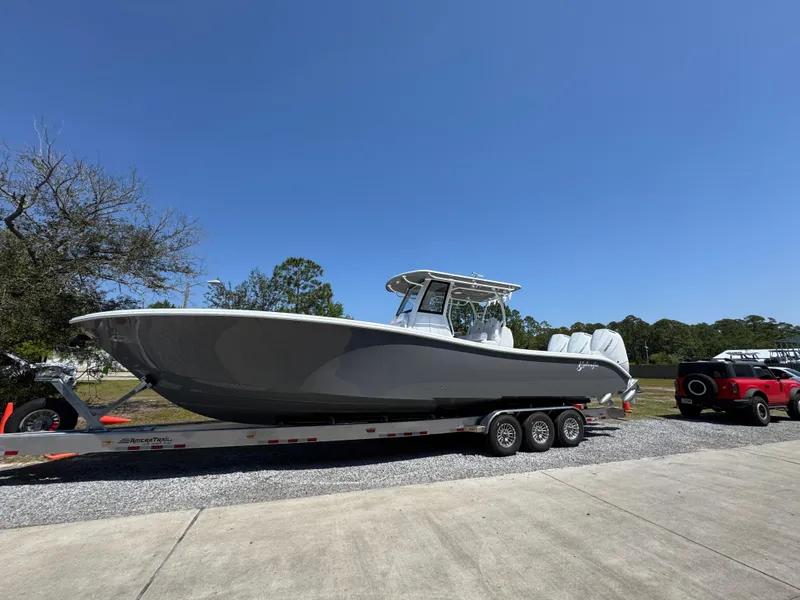 Slide: The Image of 2025 Yellowfin 36 Offshore boat on trailer under clear blue sky. - 11