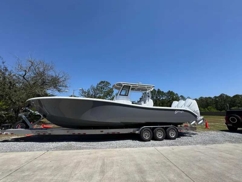 Slide: The Image of 2025 Yellowfin 36 Offshore boat on trailer, parked outdoors under clear blue sky. - 12