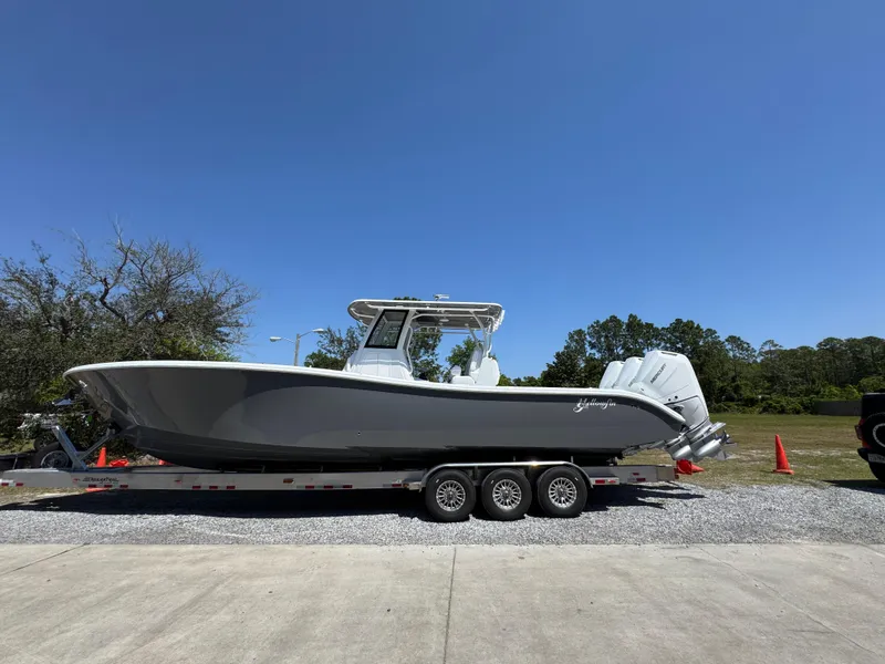 Slide: The Image of 2025 Yellowfin 36 Offshore boat on trailer under clear blue sky. - 13