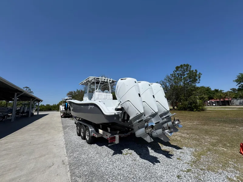 Slide: The Image of 2025 Yellowfin 36 Offshore boat with triple outboard engines on a trailer. - 18