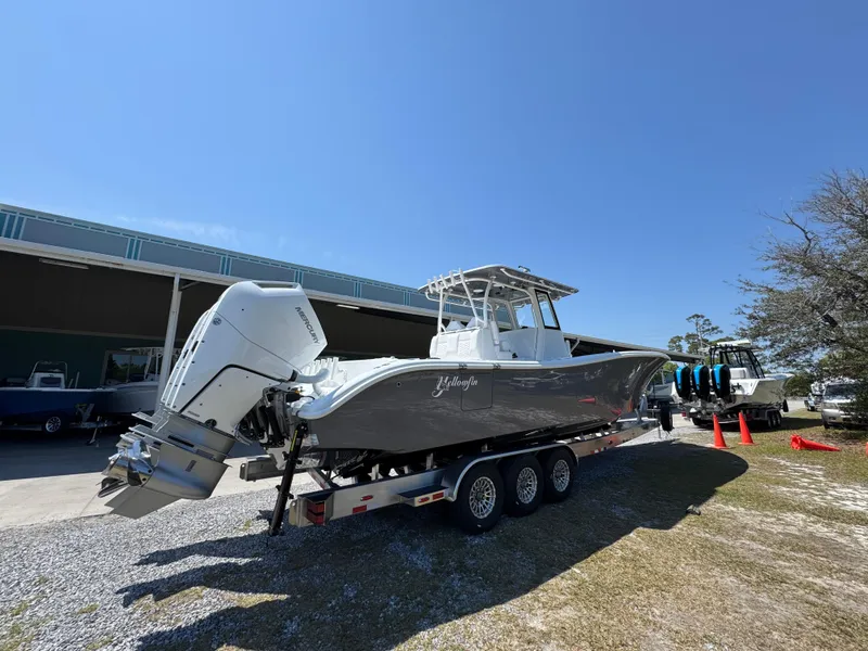 Slide: The Image of 2025 Yellowfin 36 Offshore boat on trailer, parked outdoors under clear blue sky. - 23