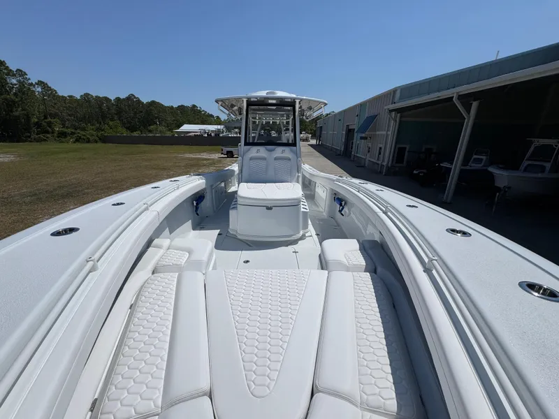 Slide: The Image of 2025 Yellowfin 36 Offshore boat with spacious deck and seating, docked near a marina. - 27