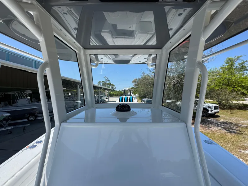 Slide: The Image of 2025 Yellowfin 36 Offshore boat interior with modern helm and clear canopy view. - 38
