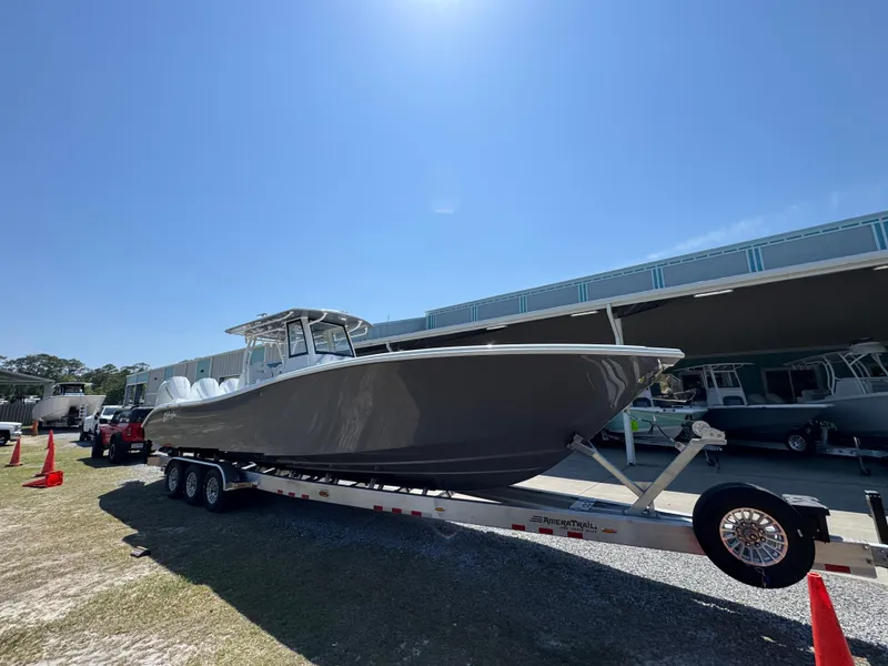 Slide: The Image of 2025 Yellowfin 36 Offshore boat on trailer under clear blue sky. - 4
