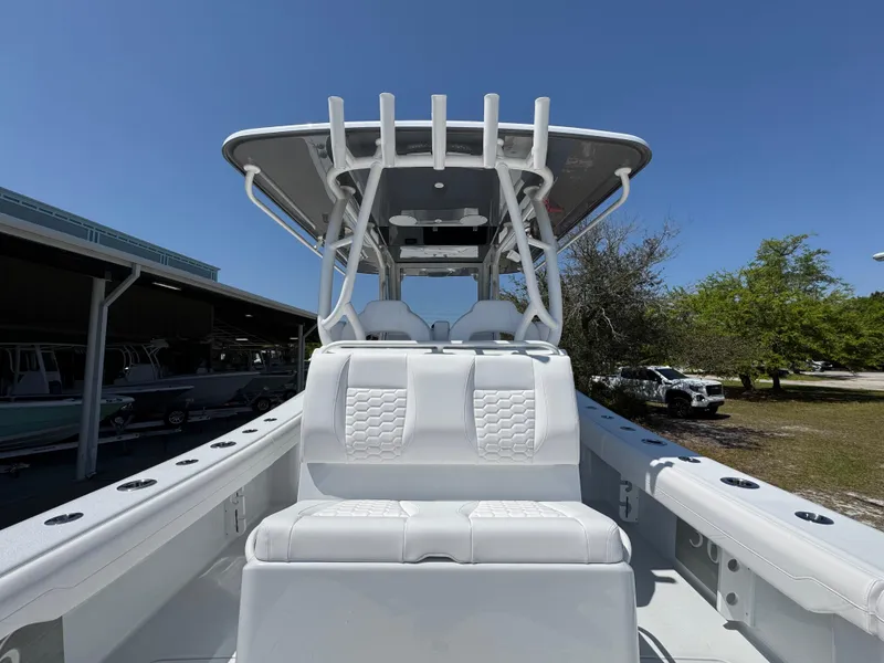 Slide: The Image of 2025 Yellowfin 36 Offshore boat with T-top and seating, under clear blue sky. - 40