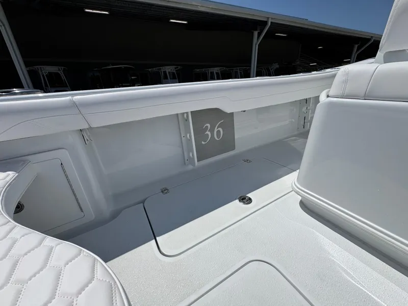 Slide: The Image of 2025 Yellowfin 36 Offshore boat interior, showcasing sleek white seating and storage area. - 44