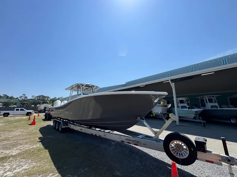 Slide: The Image of 2025 Yellowfin 36 Offshore boat on trailer under clear blue sky. - 5