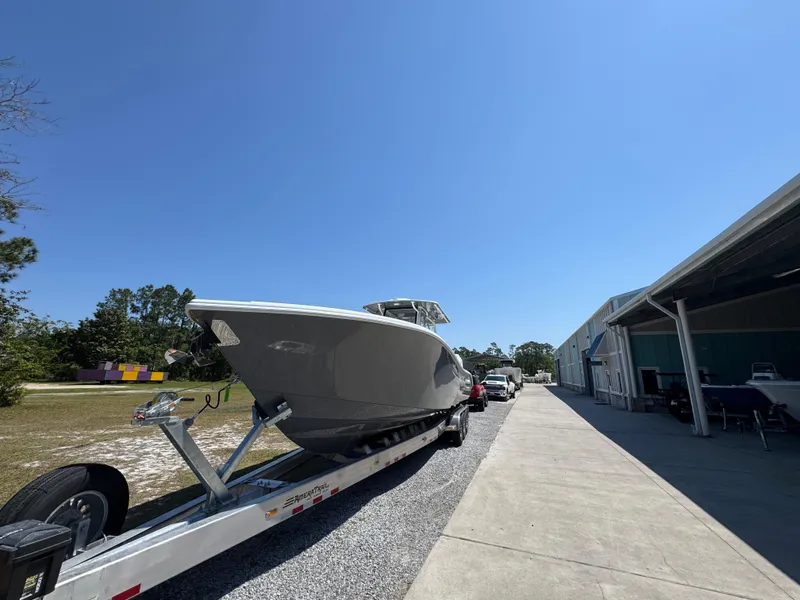 Slide: The Image of 2025 Yellowfin 36 Offshore boat on trailer, parked outdoors under clear blue sky. - 8