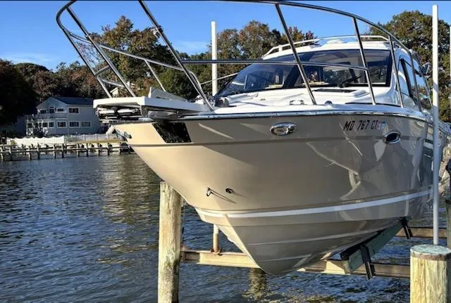 Slide: The Image of 2019 Cutwater C-242 Coupe boat docked on a serene waterfront. - 0