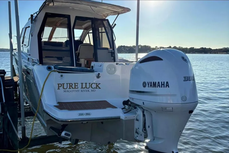 Slide: The Image of 2019 Cutwater C-242 Coupe boat with Yamaha engine, docked on Magothy River. - 1