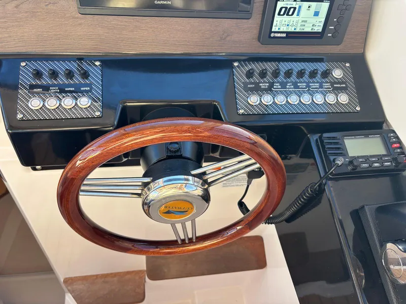 Slide: The Image of 2019 Cutwater C-242 Coupe dashboard with wooden steering wheel and control panels. - 10