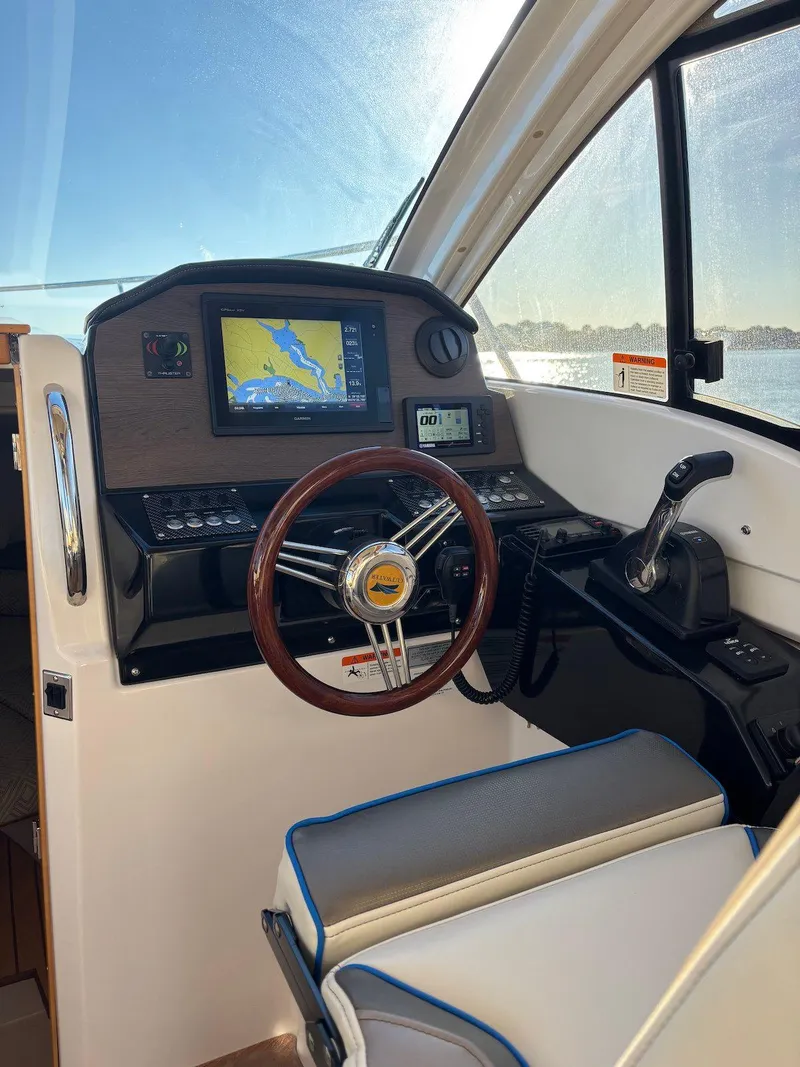 Slide: The Image of 2019 Cutwater C-242 Coupe helm with navigation display and steering wheel. - 11
