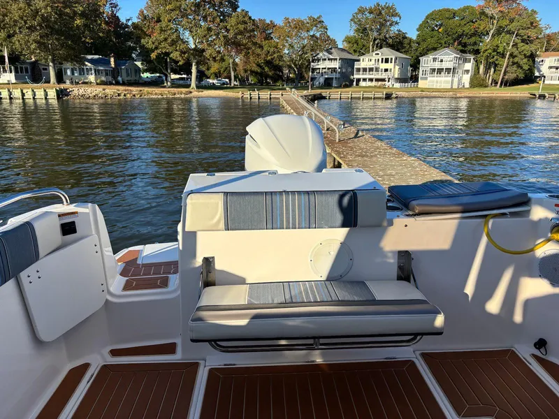 Slide: The Image of 2019 Cutwater C-242 Coupe boat docked by a scenic waterfront with houses. - 12