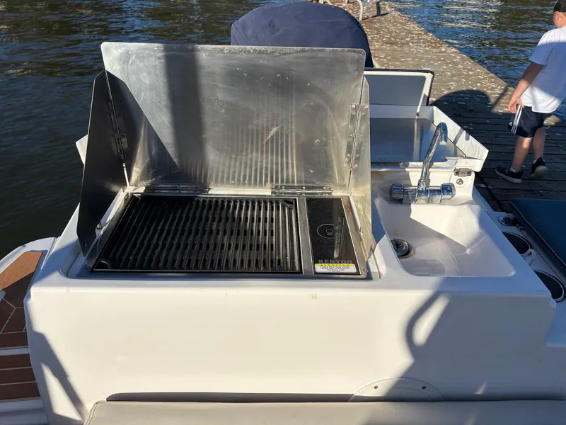 Slide: The Image of Outdoor grill and sink on 2019 Cutwater C-242 Coupe boat, dockside view. - 14