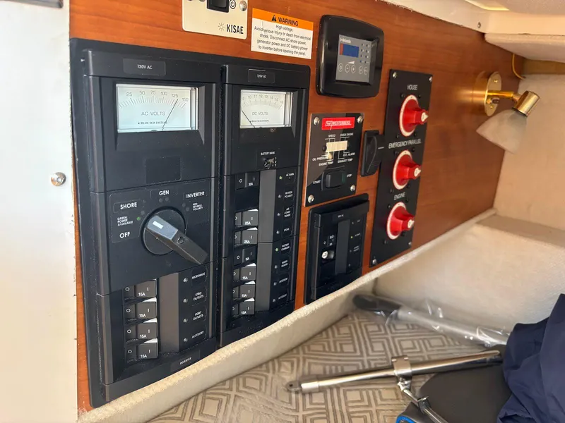 Slide: The Image of Control panel of a 2019 Cutwater C-242 Coupe boat, featuring switches and meters. - 18
