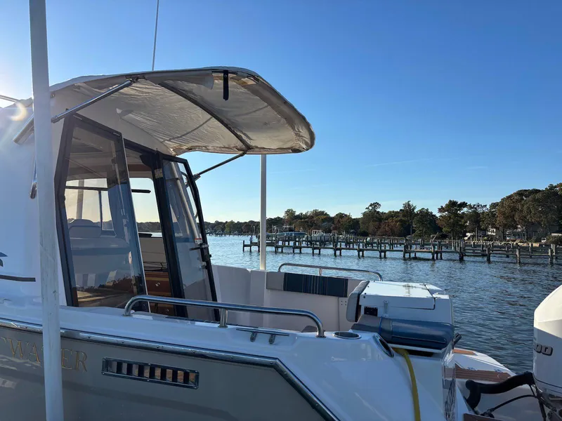 Slide: The Image of 2019 Cutwater C-242 Coupe boat docked by a scenic waterfront. - 26