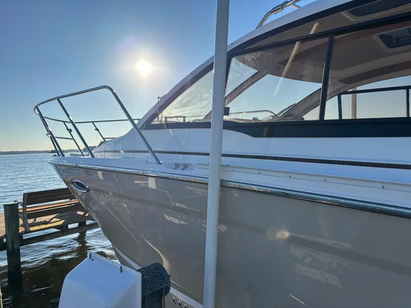 Slide: The Image of 2019 Cutwater C-242 Coupe boat docked by the water under a clear sky. - 27