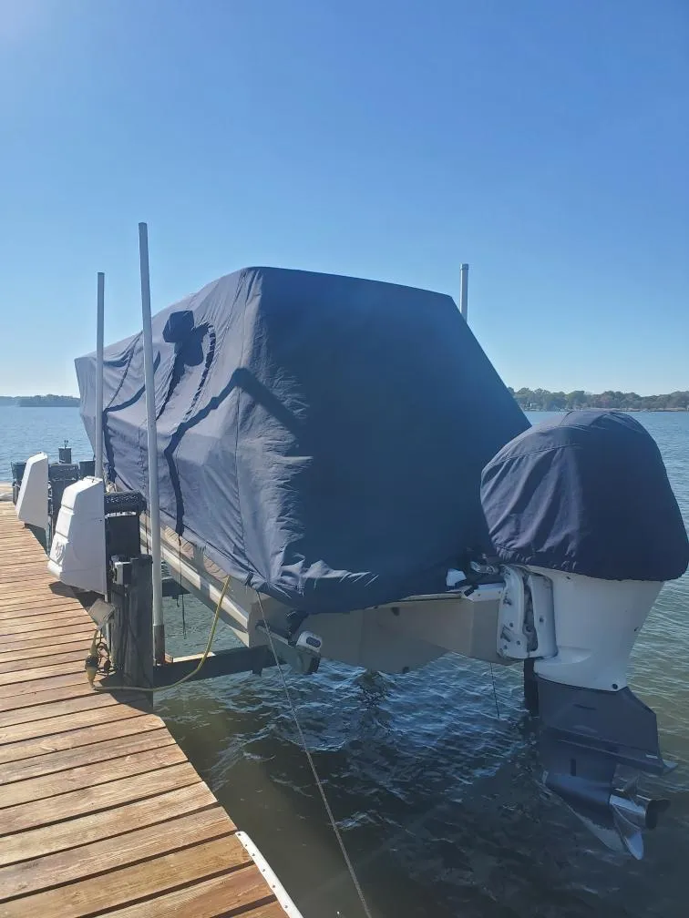 Slide: The Image of 2019 Cutwater C-242 Coupe boat covered at dock on sunny day. - 29