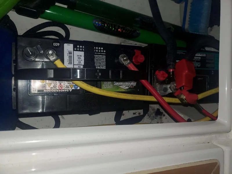 Slide: The Image of Battery compartment of a 2019 Cutwater C-242 Coupe with connected cables. - 30