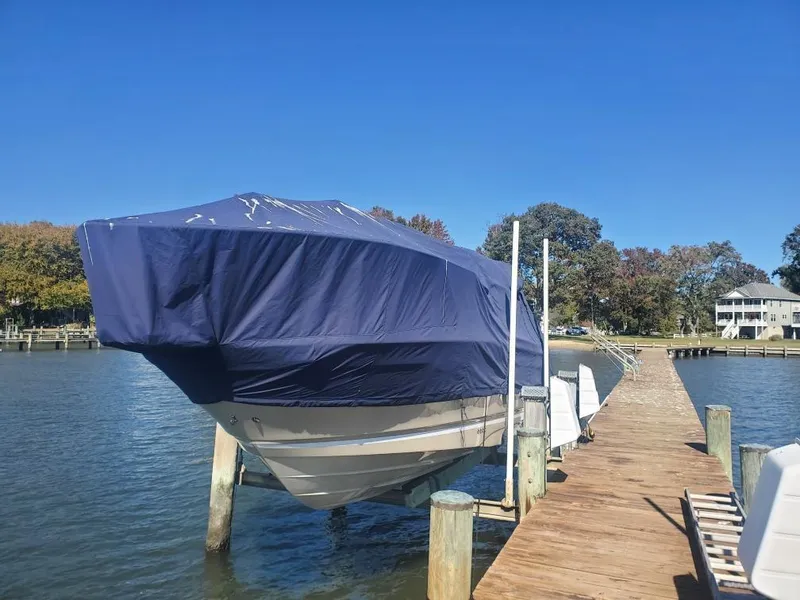 Slide: The Image of 2019 Cutwater C-242 Coupe boat covered and docked on a sunny day. - 31
