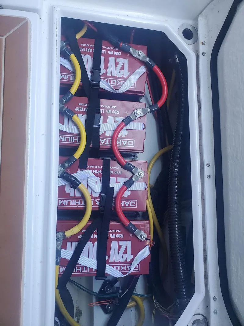 Slide: The Image of Battery compartment of a 2019 Cutwater C-242 Coupe with multiple connected batteries. - 32