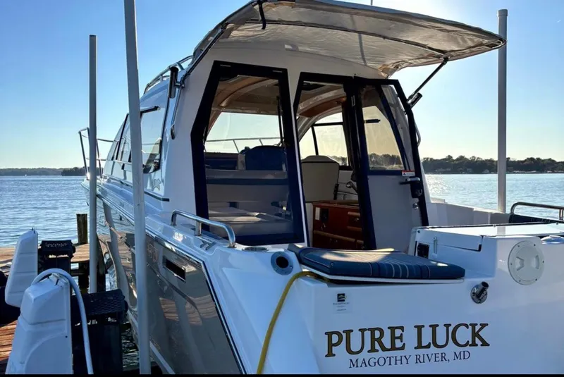 Slide: The Image of 2019 Cutwater C-242 Coupe boat docked, named "Pure Luck," on Magothy River, MD. - 4