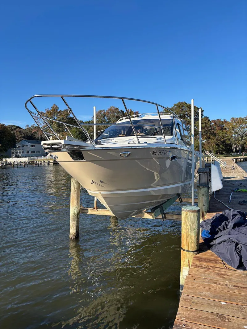Slide: The Image of 2019 Cutwater C-242 Coupe boat docked on a sunny day by the water. - 5
