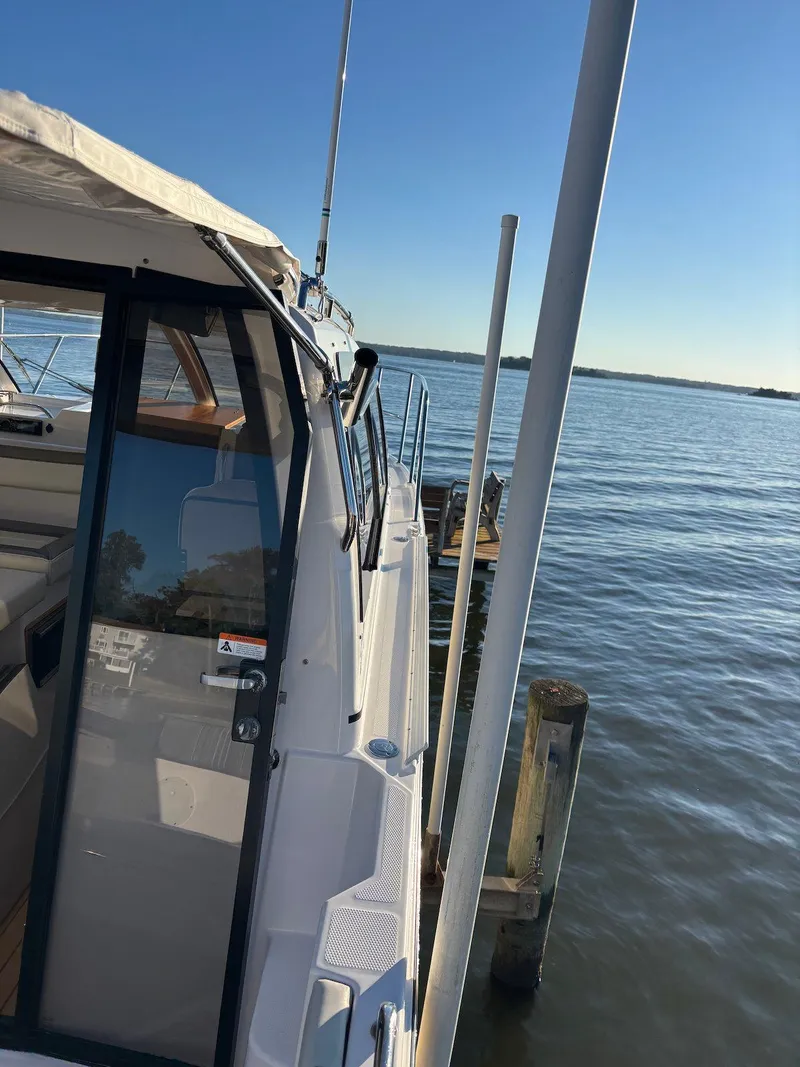 Slide: The Image of 2019 Cutwater C-242 Coupe docked by calm waters under clear blue sky. - 8