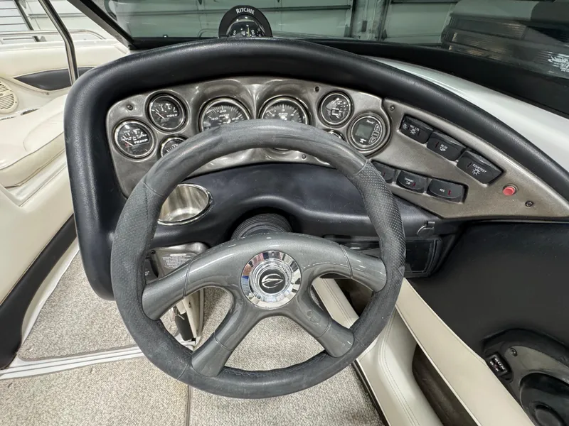 Slide: The Image of Steering wheel and dashboard of a 2006 Crownline 21 Classic boat. - 14