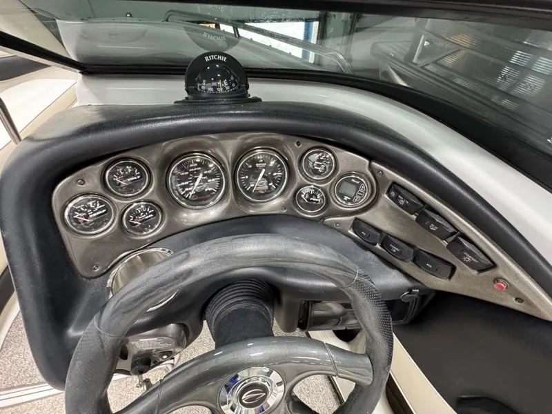 Slide: The Image of 2006 Crownline 21 Classic dashboard with gauges and steering wheel. - 15