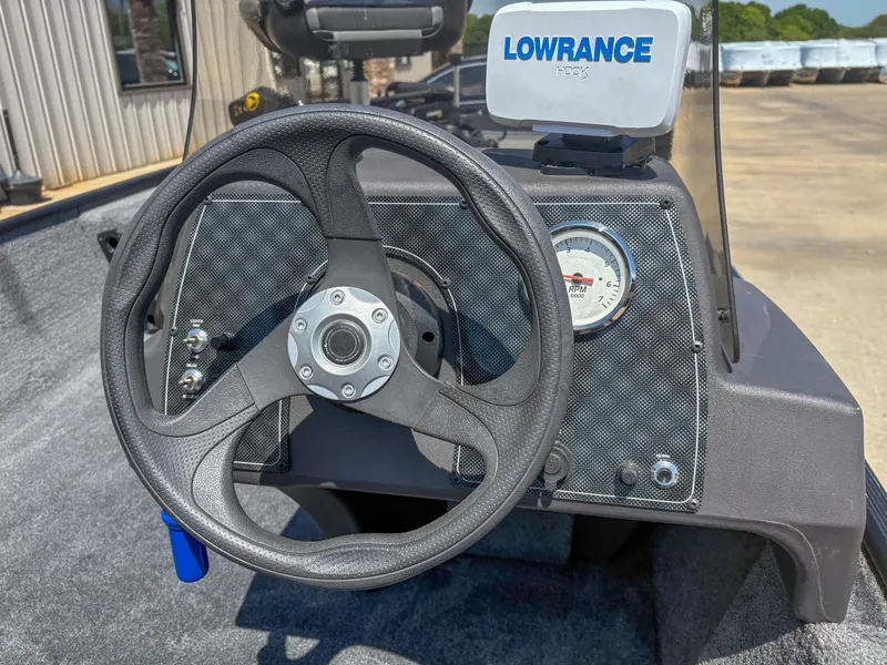Slide: The Image of 2023 Bass Tracker Classic XL dashboard with steering wheel and Lowrance GPS system. - 11