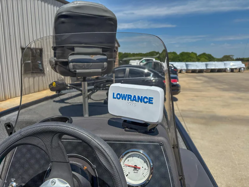 Slide: The Image of 2023 Bass Tracker Classic XL boat dashboard with Lowrance GPS and steering wheel. - 12