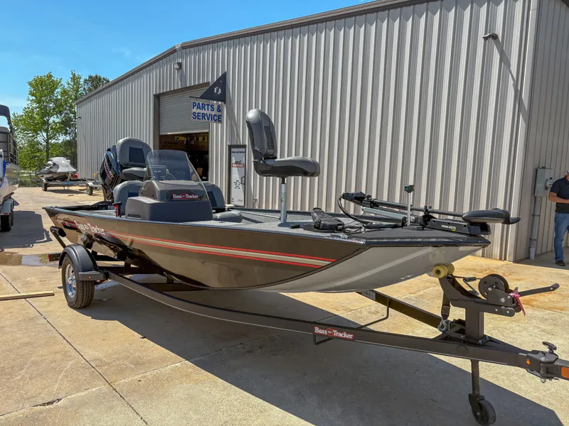 Slide: The Image of 2023 Bass Tracker Classic XL boat on trailer outside service center. - 3