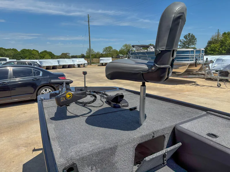 Slide: The Image of 2023 Bass Tracker Classic XL boat with swivel seat and control panel, parked outdoors. - 5