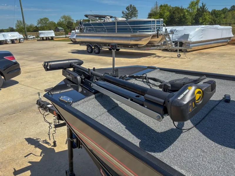 Slide: The Image of 2023 Bass Tracker Classic XL boat with trolling motor, parked outdoors on a sunny day. - 6