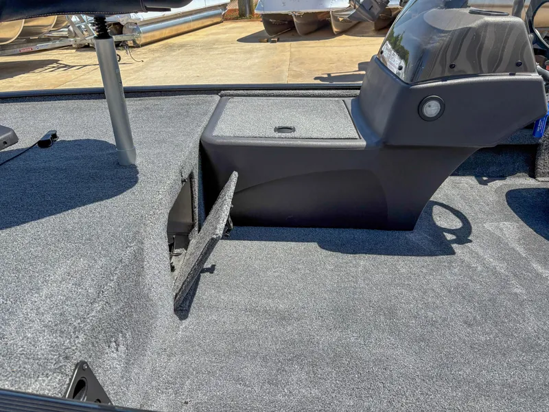 Slide: The Image of 2023 Bass Tracker Classic XL boat interior with storage compartment and console. - 8