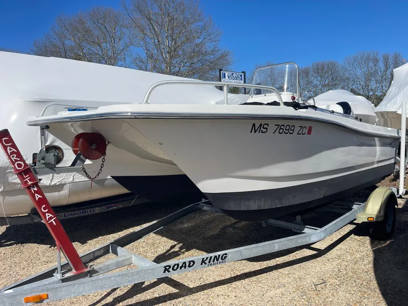 Slide: The Image of 2011 Carolina Cat 18CC boat on a Road King trailer, parked outdoors. - 1