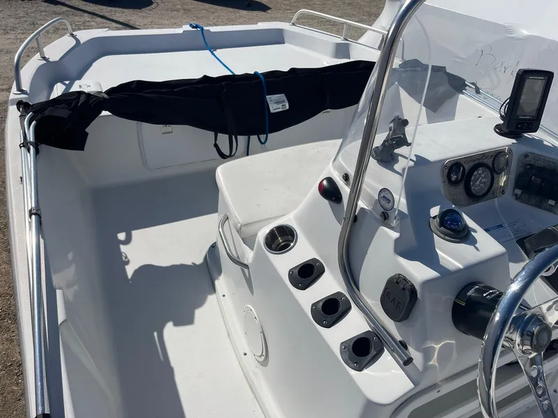 Slide: The Image of 2011 Carolina Cat 18CC boat interior with steering console and seating area. - 11