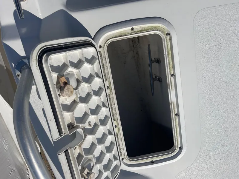 Slide: The Image of Open storage compartment on a 2011 Carolina Cat 18CC boat. - 18