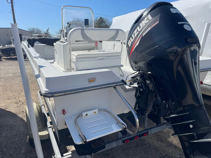 Slide: The Image of 2011 Carolina Cat 18CC boat with Suzuki outboard motor, parked on a trailer. - 4