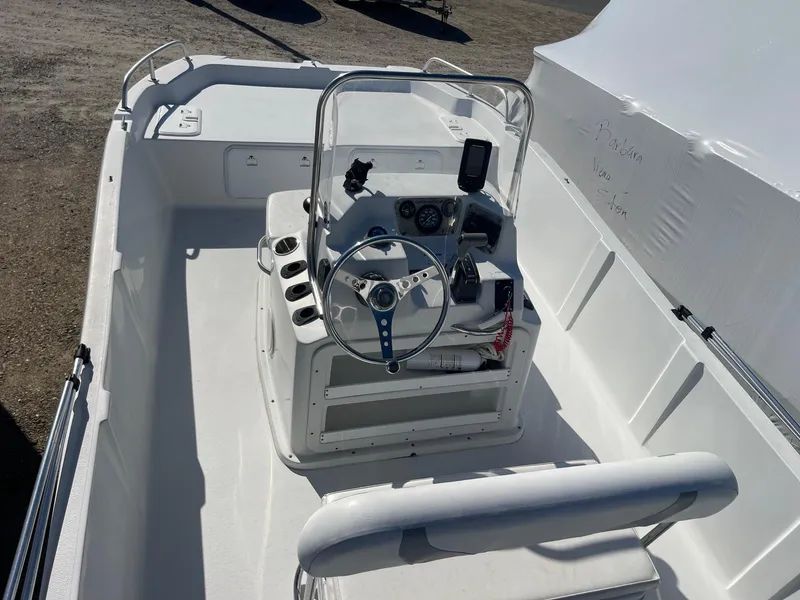 Slide: The Image of 2011 Carolina Cat 18CC boat interior with steering console and seating. - 7