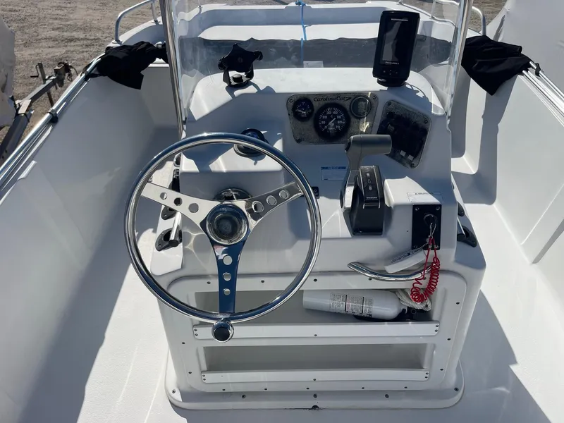 Slide: The Image of 2011 Carolina Cat 18CC boat console with steering wheel and navigation instruments. - 8