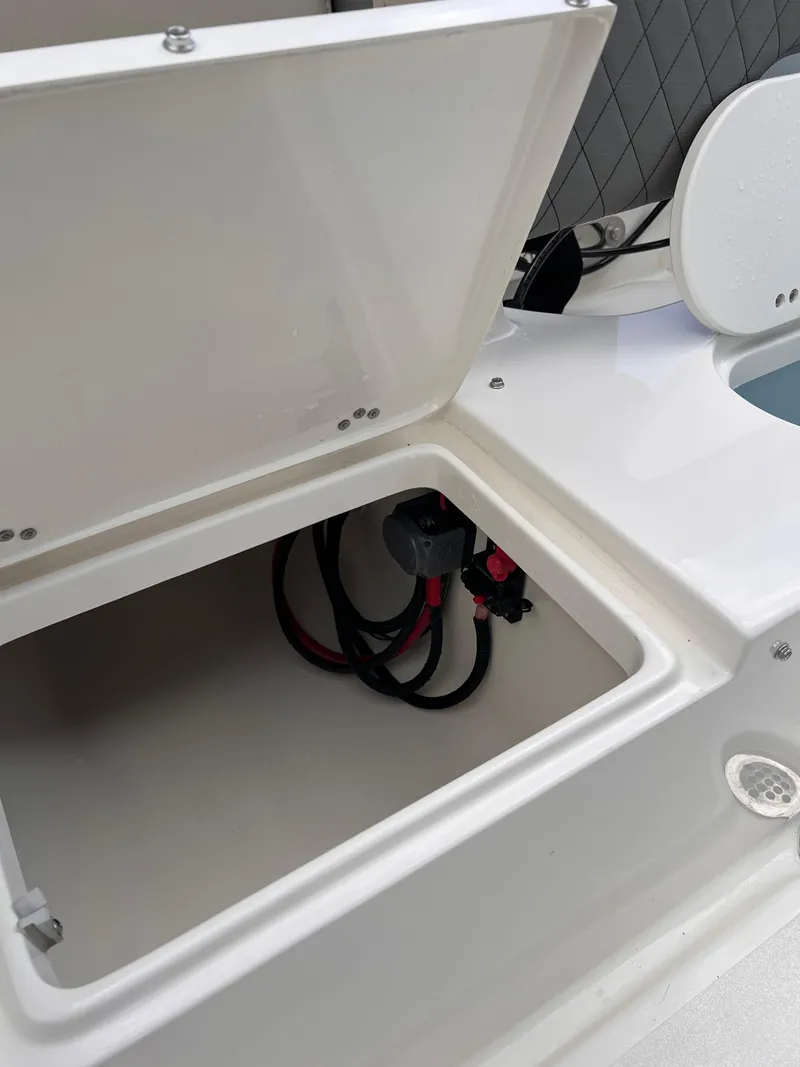 Slide: The Image of Open storage compartment on 2025 Key West 203 FS boat, showing interior wiring. - 12