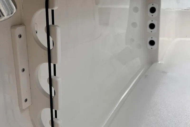 Slide: The Image of 2025 Key West 203 FS boat interior detail with rod holders and sleek white finish. - 19