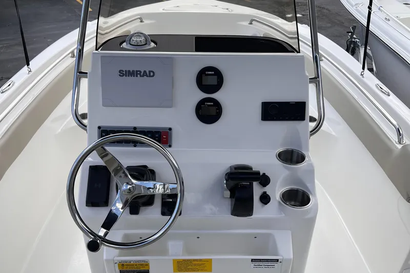 Slide: The Image of 2025 Key West 203 FS boat console with steering wheel and Simrad electronics. - 22