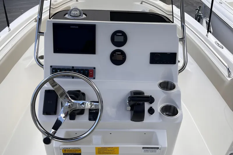Slide: The Image of 2025 Key West 203 FS boat console with steering wheel and navigation controls. - 23