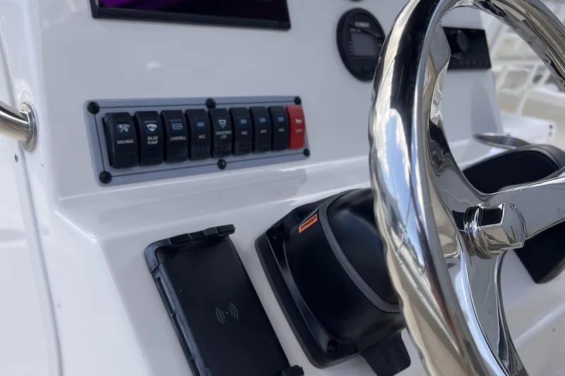 Slide: The Image of 2025 Key West 203 FS boat dashboard with steering wheel and control panel. - 24