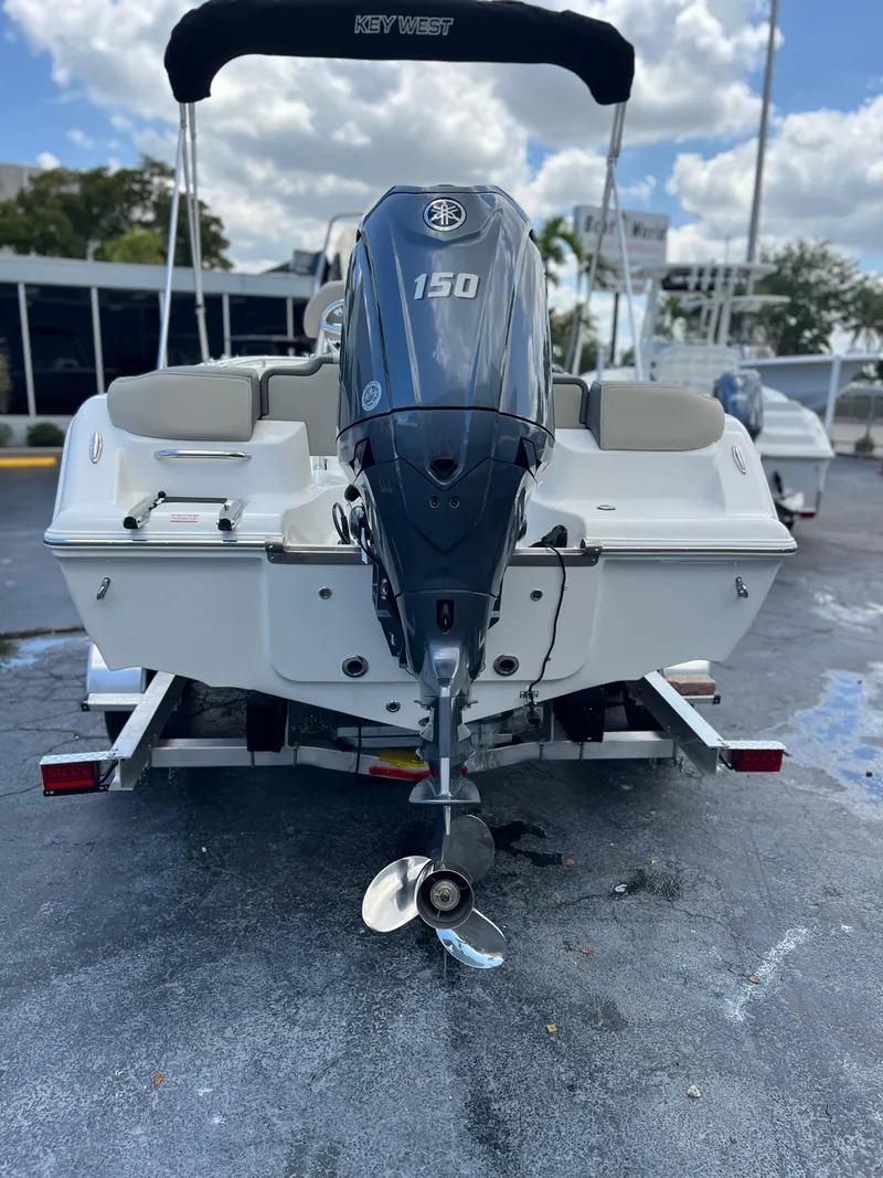 Slide: The Image of 2025 Key West 203 FS boat with 150 HP engine, rear view on trailer. - 4