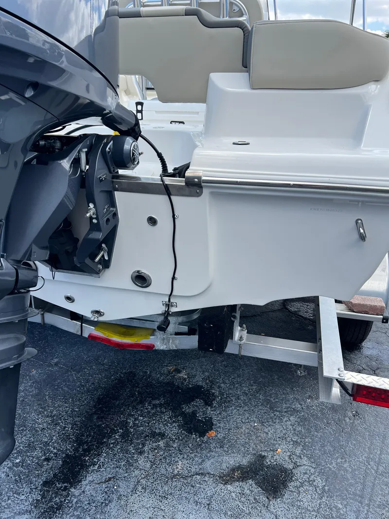 Slide: The Image of 2025 Key West 203 FS boat on trailer, rear view showing motor and hull details. - 6