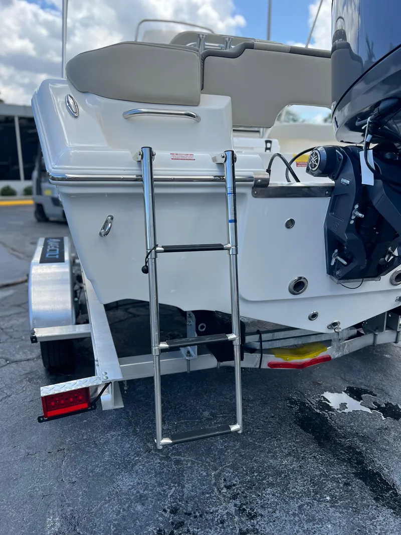 Slide: The Image of 2025 Key West 203 FS boat with ladder and motor on trailer. - 7